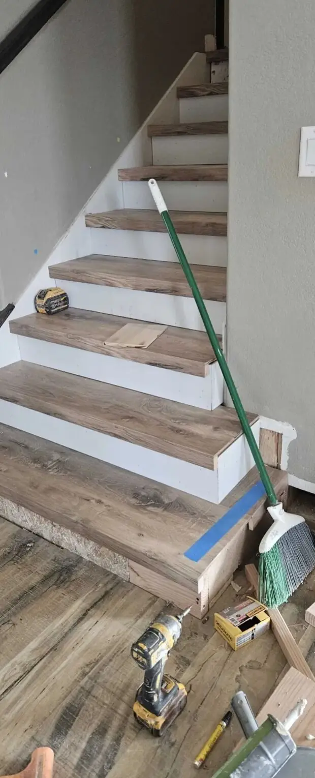 Custom LVP staircase install by Above Grade Flooring in Denver